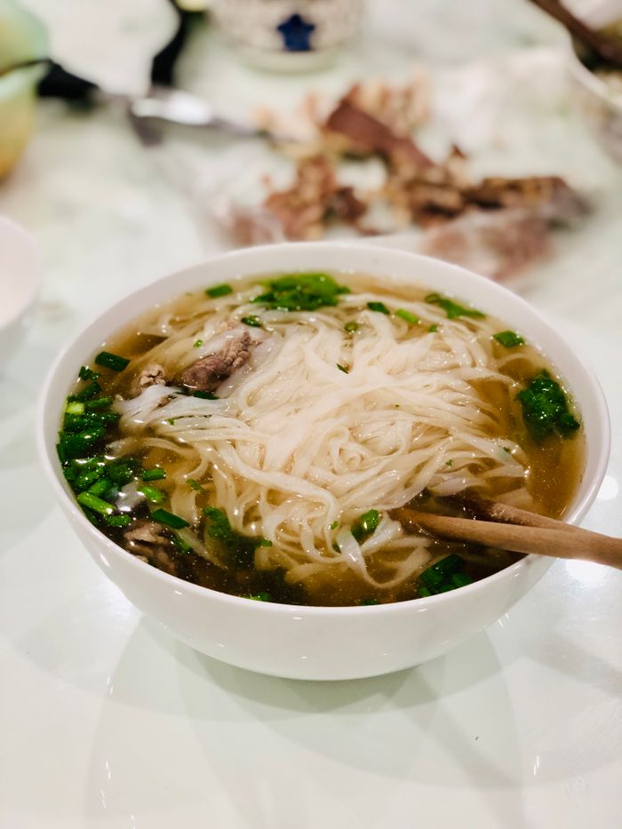 Delicious Vietnamese pho noodle soup with beef and greens in a ceramic bowl, taken in Haiphong, Vietnam.