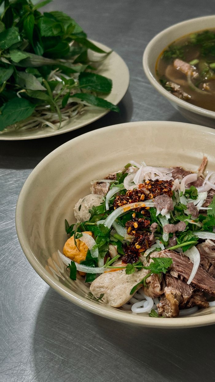 Delicious Vietnamese pho served with fresh herbs and spices, capturing the essence of Ho Chi Minh City's vibrant cuisine.